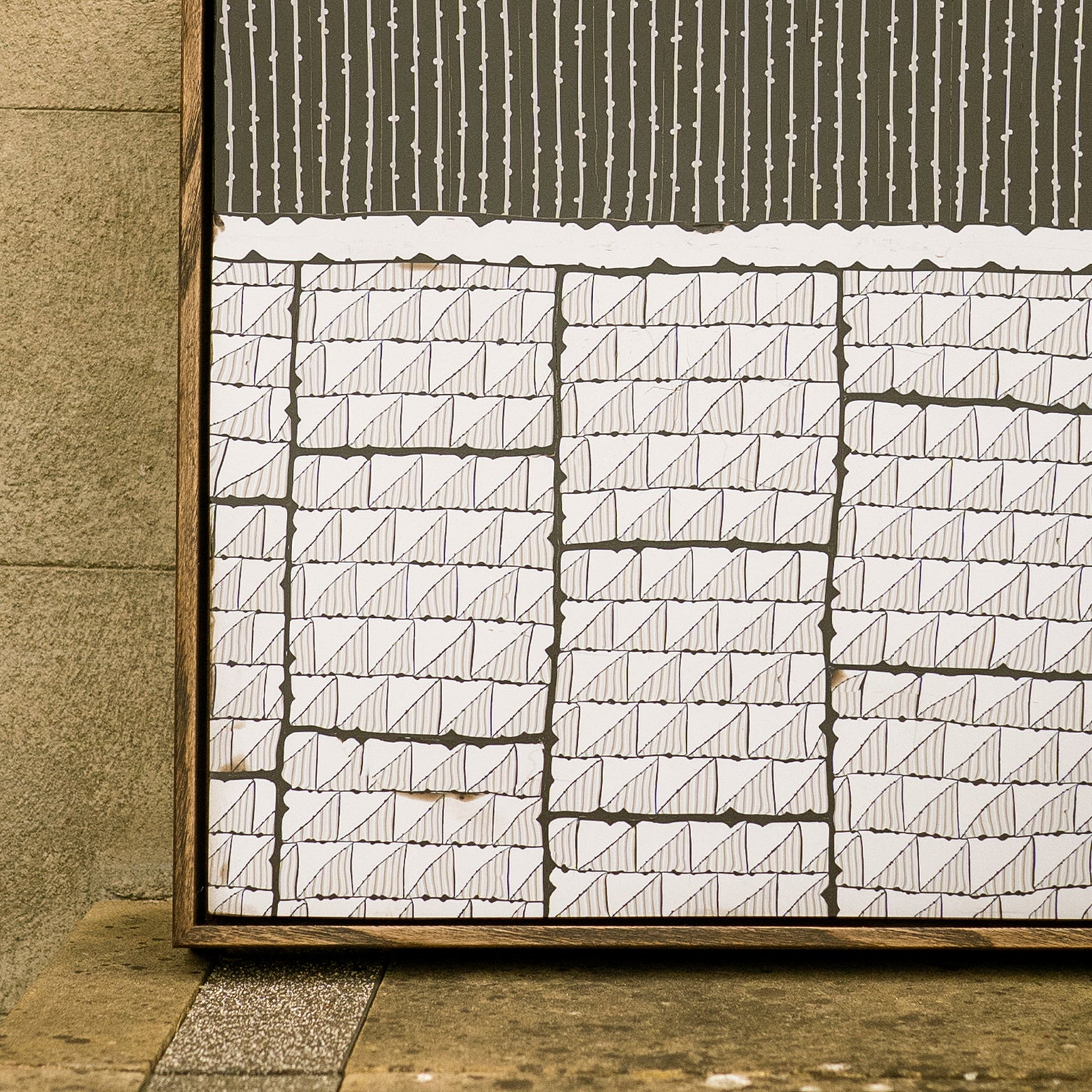 A close-up of Steppe, a monochromatic abstract polymer clay artwork featuring geometric patterning and layered architectural forms.