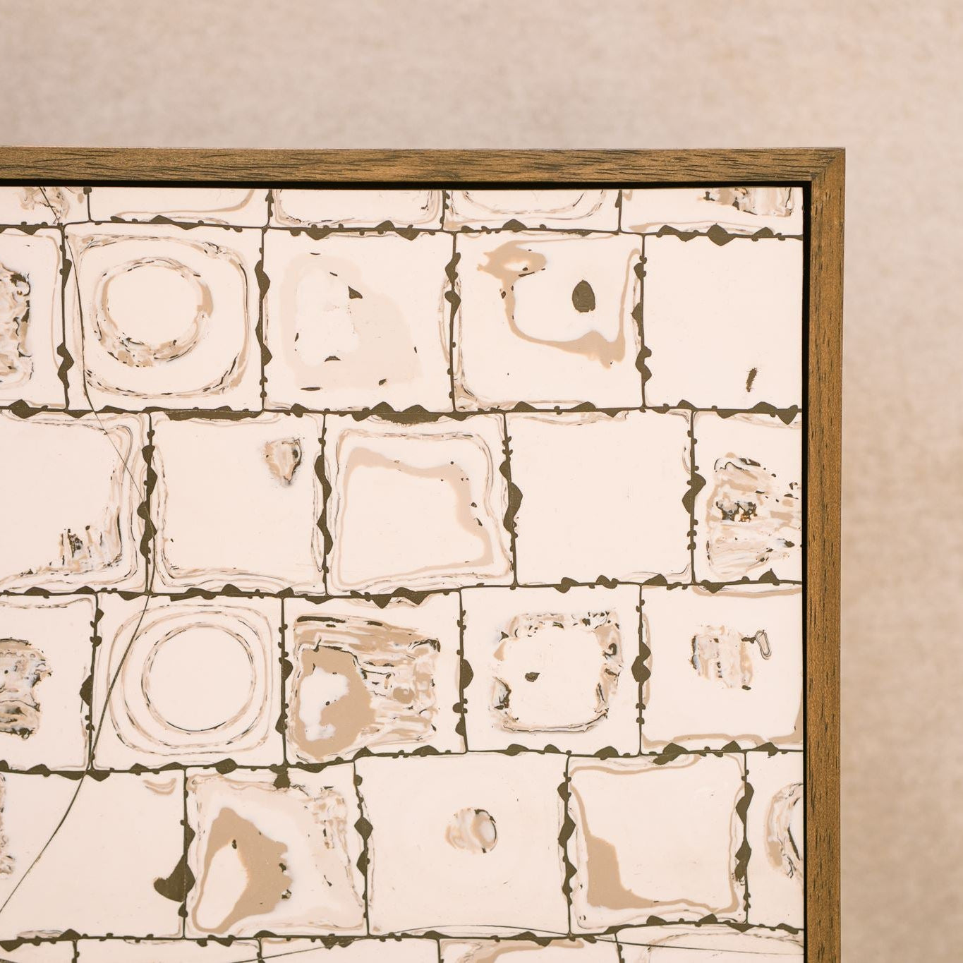 Close-up detail of Ēa by Studio Anna, showing the artwork's layered polymer clay surface within a walnut-stained wooden tray frame. The composition features an orderly grid of soft ivory and warm beige forms outlined with fine dark brown lines, revealing subtle variations in texture and handcrafted detail.