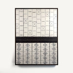 Ende, a contemporary abstract polymer clay artwork composed of geometric off-white and black forms arranged in a structured grid. The upper section features rectangular blocks interrupted by occasional crossed squares, while the lower section is defined by repeating diamond motifs. A bold horizontal dark brown black band divides the composition, creating a strong architectural balance between the two halves. Presented in a solid wood tray frame finished in dark English walnut, measuring 47.5 × 63 cm.