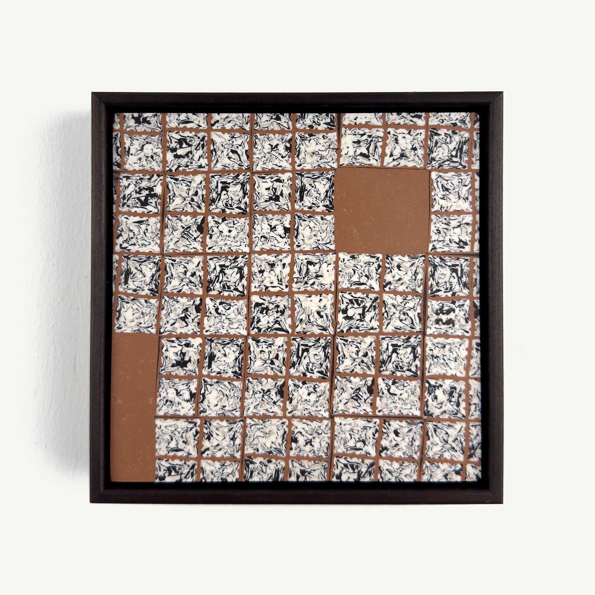 Greót II, by artist Anna Mills, a contemporary abstract polymer clay artwork featuring a grid of individually sliced black, white and beige patterned squares arranged around open terracotta-coloured negative spaces. The composition is presented in a solid wood veneer tray frame finished in dark English walnut, measuring 17 × 17 cm.