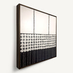 Heġe, a contemporary abstract polymer clay artwork measuring 52 × 52 cm, by artist Anna Mills. A minimalist composition combines a spacious off-white upper field with a central band of hand-cut organic geometric forms outlined by fine black lines, anchored by a bold black section of delicate vertical linework below. Subtle handcrafted textures and irregularities create a quiet balance between structure and organic movement. Presented in a solid wood tray frame finished in dark English walnut.