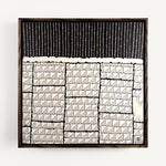 Steppe, a contemporary abstract polymer clay artwork measuring 32 × 32 cm, by artist Anna Mills. A bold black upper section of fine vertical lines contrasts with a structured arrangement of hand-cut ivory geometric tiles below, each marked with delicate linear details. Irregular edges, subtle surface variations and visible handcrafted textures create a quiet balance between order and organic imperfection. Presented in a solid wood tray frame finished in dark English walnut.