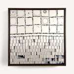 Wer, a contemporary abstract polymer clay artwork measuring 32 × 32 cm, by artist Anna Mills. A minimalist composition contrasts a grid of hand-cut ivory tiles with soft concentric forms above a field of finely sliced vertical clay strips below. Fine black linework, subtle marbled details and organic surface variations celebrate the handcrafted nature of the medium while balancing structure with quiet imperfection. Presented in a solid wood tray frame finished in dark English walnut.